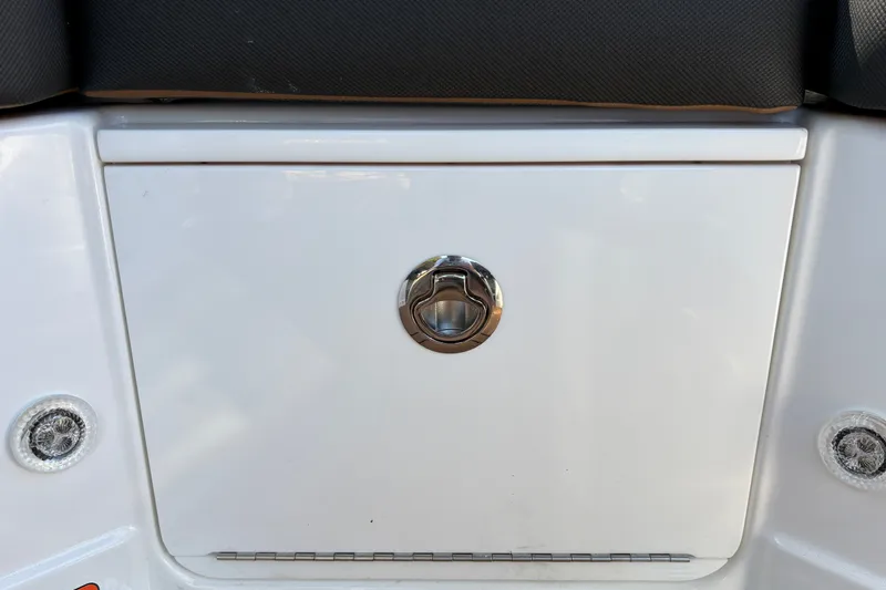 Slide: The Image of 2027 Tahoe 210 S boat storage compartment with chrome handle and sleek design. - 44