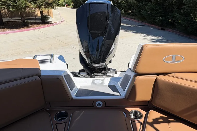 Slide: The Image of 2027 Tahoe 210 S boat interior with brown seating and outboard motor. - 37