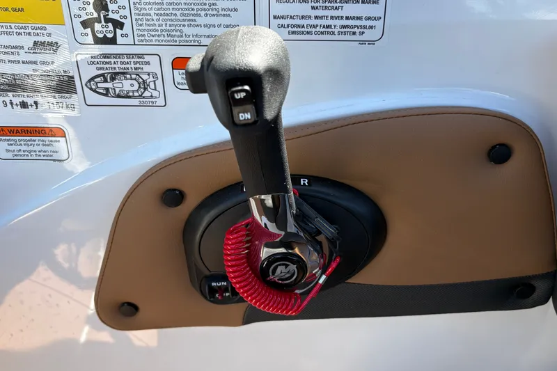 Slide: The Image of Throttle control lever on a 2027 Tahoe 210 S boat dashboard with safety warnings. - 42