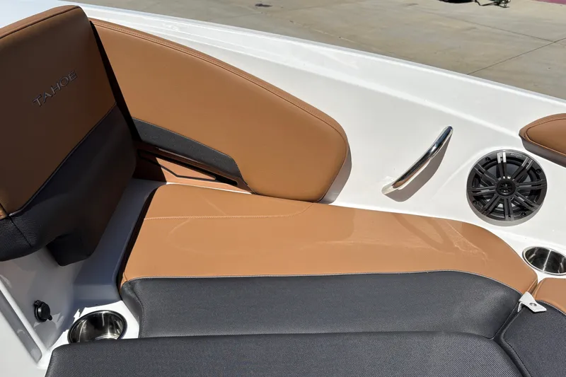 Slide: The Image of 2027 Tahoe 210 S boat interior with tan and black seating, speaker, and cup holder. - 27