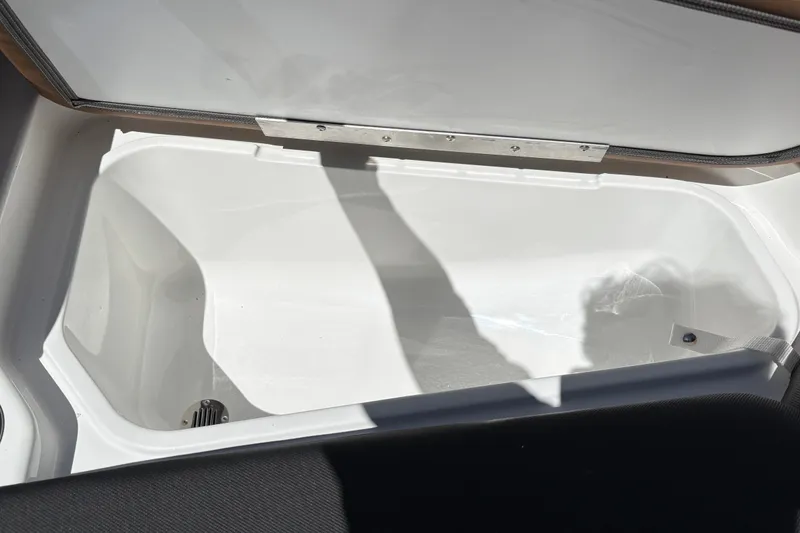 Slide: The Image of Open storage compartment in 2027 Tahoe 210 S boat, showcasing spacious interior design. - 41