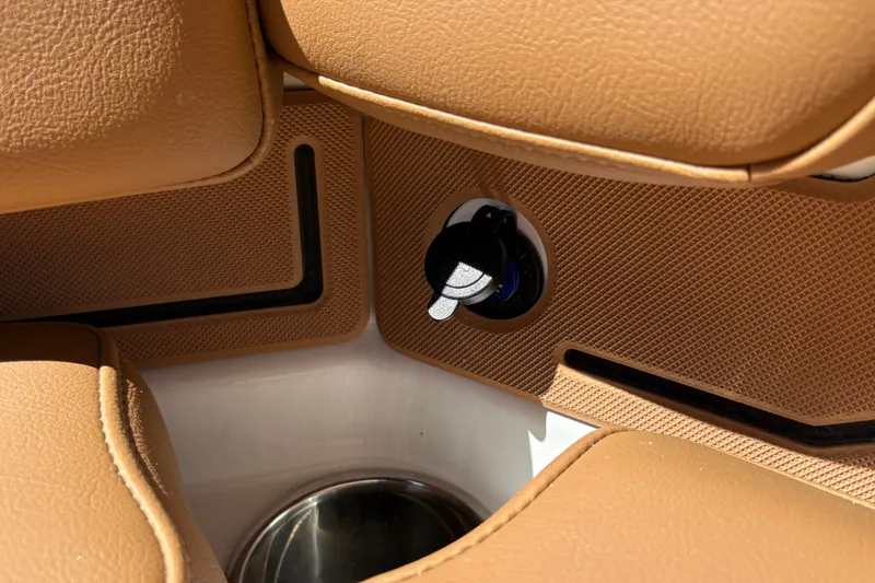 Slide: The Image of 2027 Tahoe 210 S boat interior with tan upholstery and ignition key detail. - 47