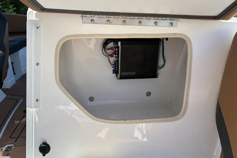 Slide: The Image of Storage compartment with audio equipment in 2027 Tahoe 210 S boat. - 34