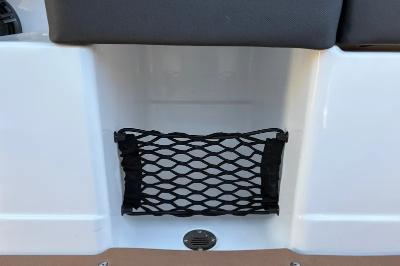 Slide: The Image of Storage net on a 2027 Tahoe 210 S boat, featuring sleek white interior design. - 53