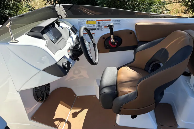 Slide: The Image of Interior of 2027 Tahoe 210 S boat with steering wheel and captain's chair. - 15