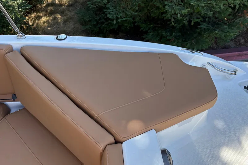 Slide: The Image of 2027 Tahoe 210 S boat with tan leather seating, outdoor setting. - 49