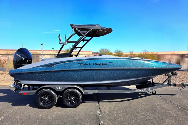The Image of 2027 Tahoe 2150 boat on trailer, sleek design, blue finish, outdoor setting. - 0