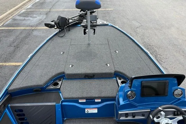 Slide: The Image of 2027 Nitro Z18 XL Pro boat with advanced dashboard and seating, parked on pavement. - 15