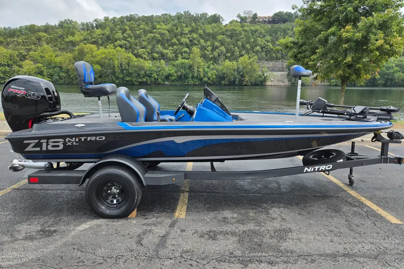 The Image of 2027 Nitro Z18 XL Pro boat on trailer by a scenic river. - 0