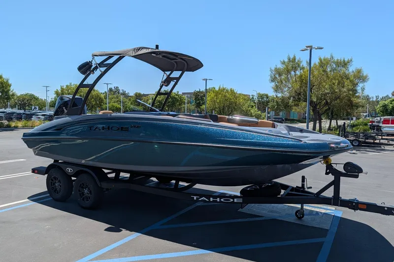 The Image of 2027 Tahoe 2150 boat on trailer in parking lot, sunny day. - 0