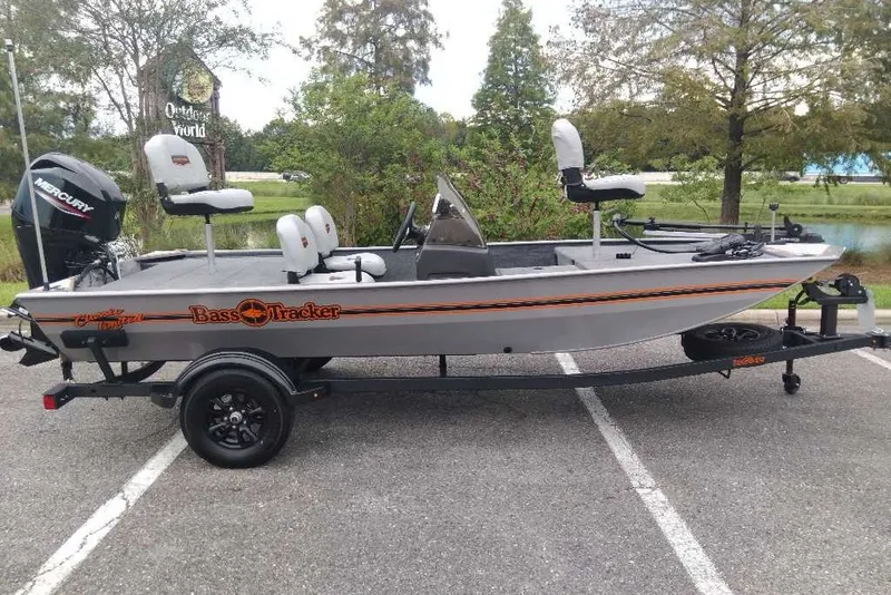 The Image of 2027 Tracker Bass Tracker Classic Limited fishing boat on trailer in parking lot. - 0