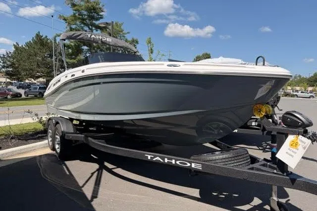 The Image of 2027 Tahoe 210 S boat on trailer, parked outdoors under a clear blue sky. - 0