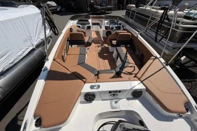 Slide: The Image of 2027 Tahoe 210 S boat interior with tan seating and modern dashboard. - 4