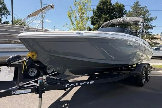 Slide: The Image of 2027 Tahoe 210 S boat on trailer, parked outdoors, under clear sky. - 1