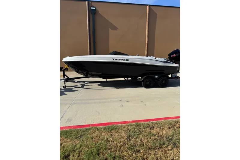 The Image of 2027 Tahoe 2150 boat on trailer, parked outdoors, side view. - 0