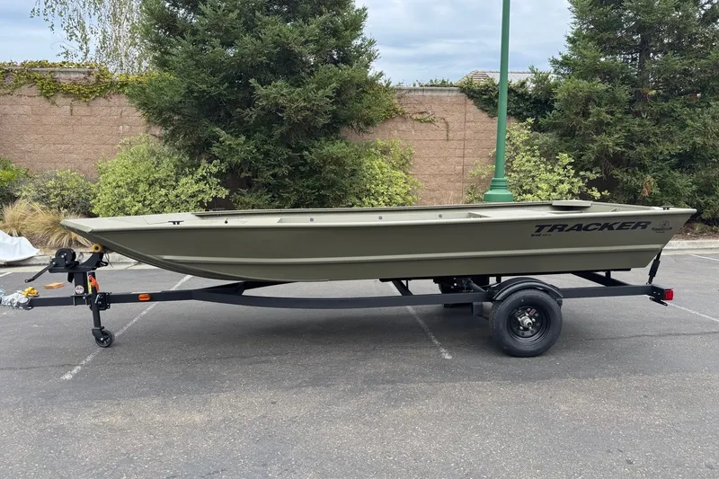 The Image of 2027 Tracker Grizzly 1648 Utility boat on trailer, parked outdoors. - 0