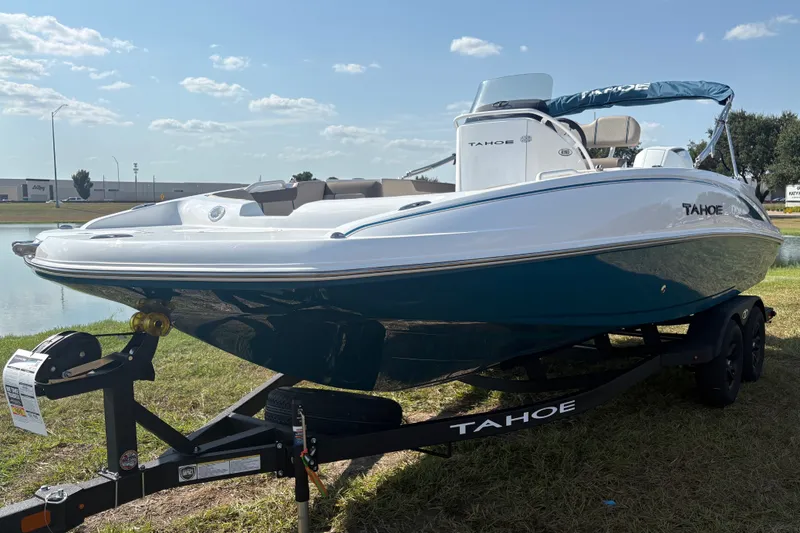 The Image of A modern 2027 Tahoe 2150 CC sits on a trailer beside a pond. - 0