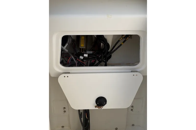 Slide: The Image of 2027 Tahoe 2150 CC boat compartment with visible wiring and components. - 17