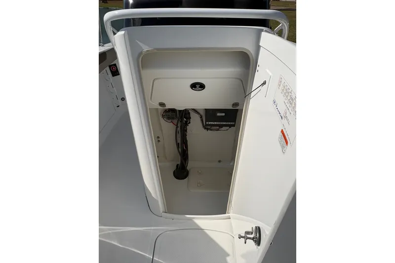 Slide: The Image of 2027 Tahoe 2150 CC boat storage compartment with wiring and control panel. - 16