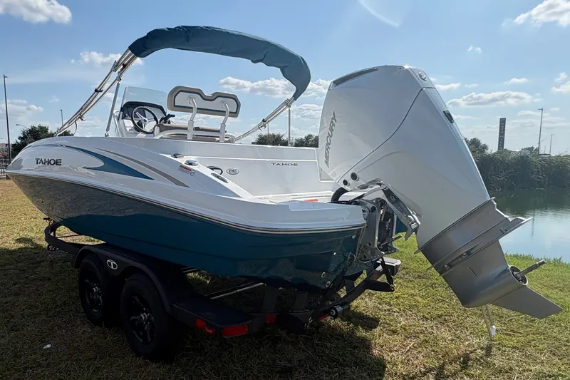 Slide: The Image of A modern 2027 Tahoe 2150 CC sits on a trailer beside a body of water. - 3