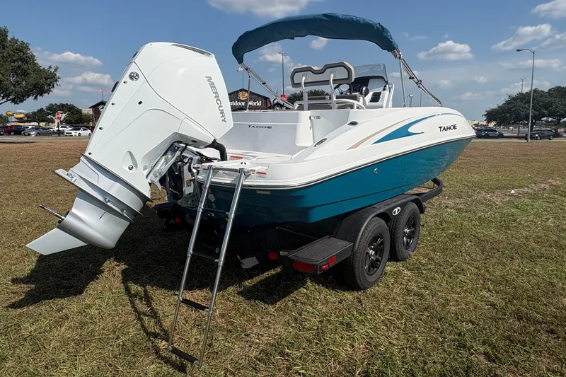 Slide: The Image of A modern 2027 Tahoe 2150 CC sits on a trailer in a grassy area under a blue sky. - 5