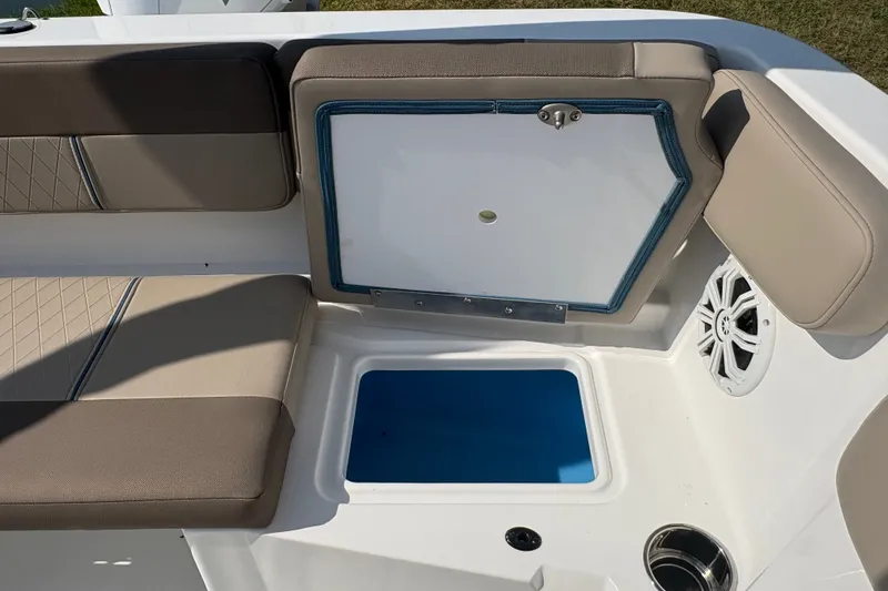 Slide: The Image of 2027 Tahoe 2150 CC boat interior with cushioned seating and storage compartment. - 19
