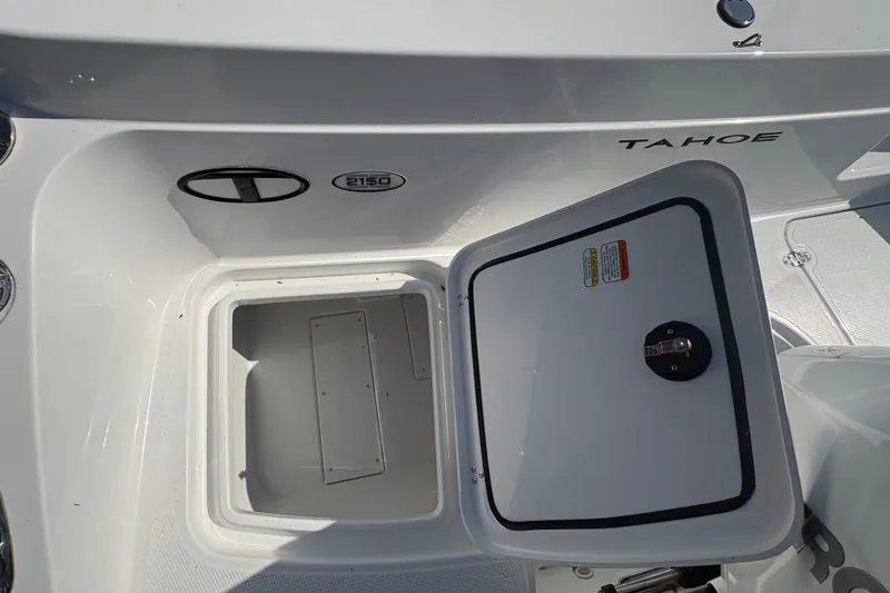 Slide: The Image of The image shows the storage compartment of a 2027 Tahoe 2150 CC boat. The area is clean and well-organized. - 9