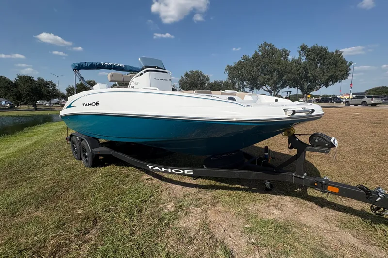 Slide: The Image of 2027 Tahoe 2150 CC boat on trailer, parked on grass under blue sky. - 7
