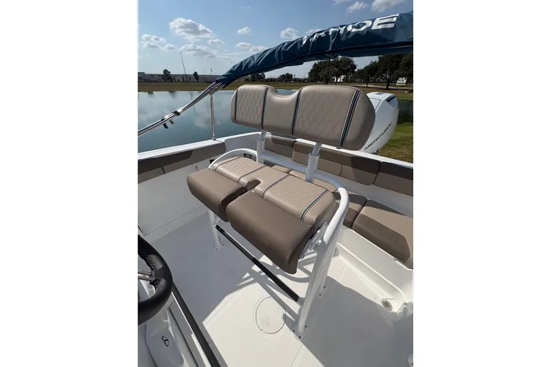 Slide: The Image of 2027 Tahoe 2150 CC boat interior with cushioned seating and steering wheel. - 21