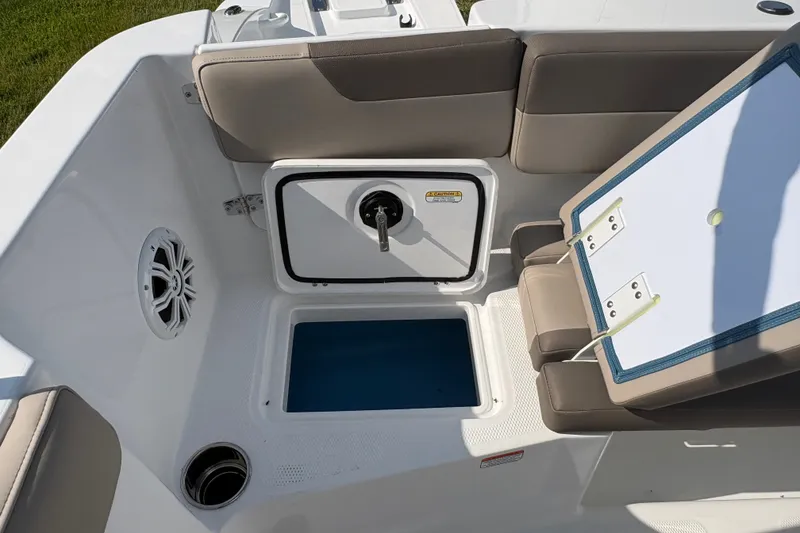 Slide: The Image of 2027 Tahoe 2150 CC boat interior with seating, storage, and speaker. - 18