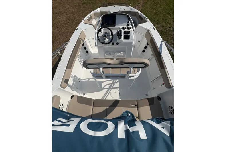 Slide: The Image of The image shows the cockpit of a 2027 Tahoe 2150 CC boat with helm and seating. - 8