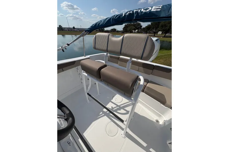 Slide: The Image of 2027 Tahoe 2150 CC boat interior with cushioned seating and steering wheel. - 20
