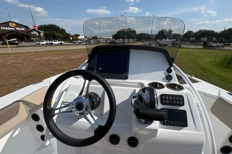 Slide: The Image of Steering console of 2027 Tahoe 2150 CC boat with modern controls and display. - 22