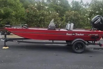 The Image of 2027 Tracker Bass Tracker Classic XL boat on trailer, parked outdoors. - 0