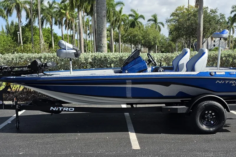 The Image of 2027 Nitro Z18 XL Pro boat in a parking lot, surrounded by palm trees. - 0