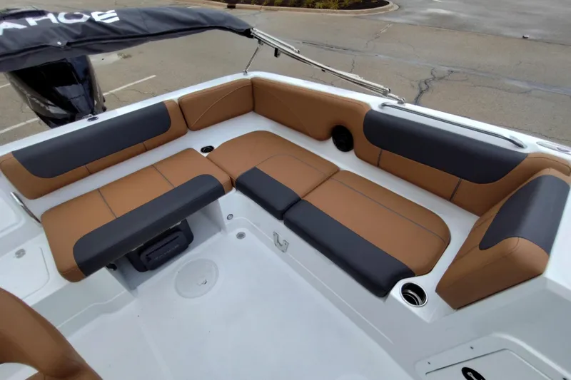 Slide: The Image of 2027 Tahoe 2150 boat interior with brown and black cushioned seating. - 13