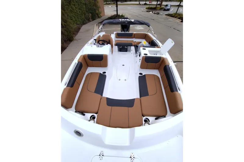Slide: The Image of 2027 Tahoe 2150 boat interior with brown and black seating, showcasing spacious design. - 4