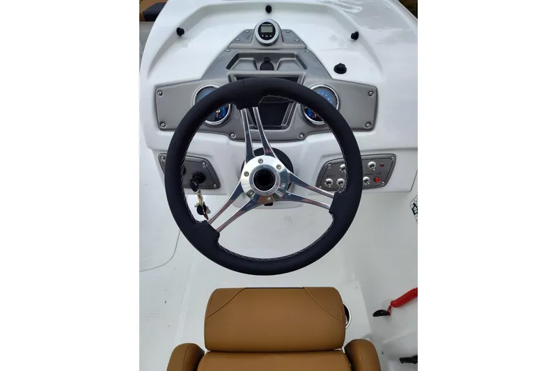 Slide: The Image of Steering wheel and dashboard of 2027 Tahoe 2150 boat, featuring modern controls and gauges. - 9