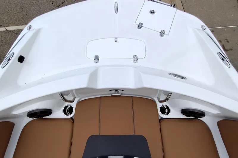 Slide: The Image of 2027 Tahoe 2150 boat interior with white deck and brown seating. - 5