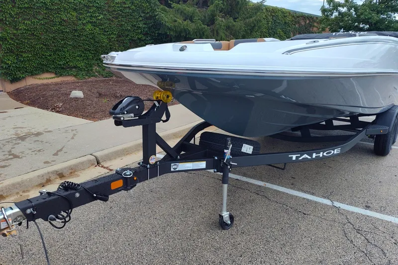 Slide: The Image of 2027 Tahoe 2150 boat on trailer, parked outdoors, showcasing sleek design and modern features. - 3