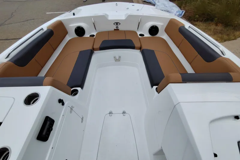 Slide: The Image of 2027 Tahoe 2150 boat interior with tan and black seating, cup holders, and spacious layout. - 6