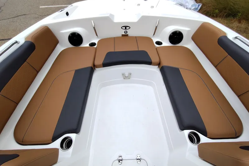 Slide: The Image of Luxurious seating area on 2027 Tahoe 2150 boat with tan and black upholstery. - 12