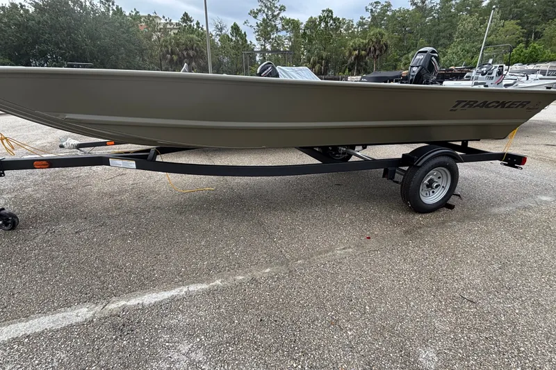 The Image of 2027 Tracker Grizzly 1648 Utility boat on trailer in parking lot. - 0