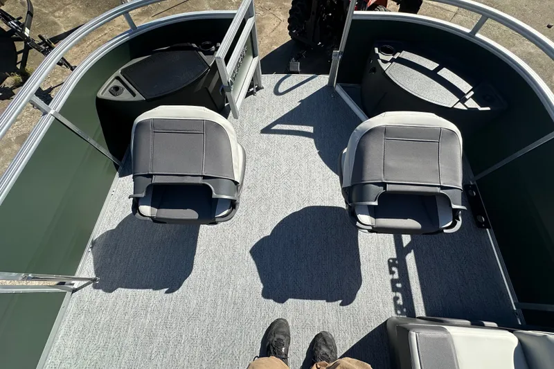 Slide: The Image of 2027 Sun Tracker Fishin' Barge 22 DLX interior with two swivel seats and carpeted deck. - 13