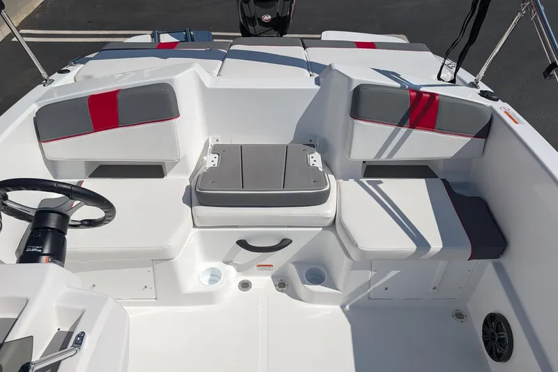 Slide: The Image of 2027 Tahoe T18 boat interior with white and red seating, steering wheel, and storage compartments. - 6