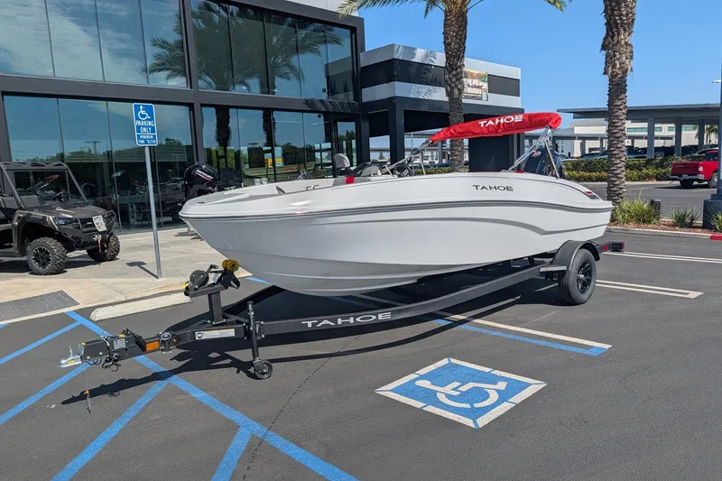 Slide: The Image of 2027 Tahoe T18 boat on trailer in parking lot, near dealership building. - 3