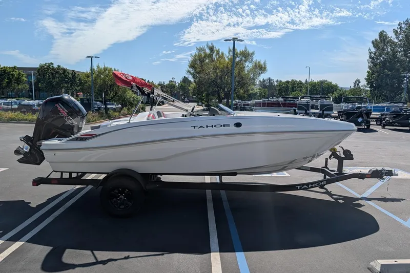 Slide: The Image of 2027 Tahoe T18 boat on trailer in parking lot under clear sky. - 4