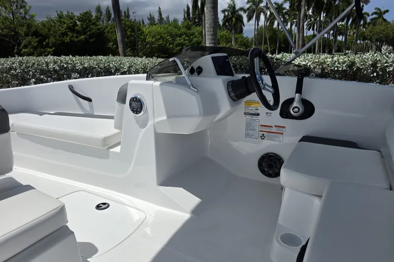 Slide: The Image of 2027 Tahoe T16 boat interior with steering wheel, seating, and control panel. - 6