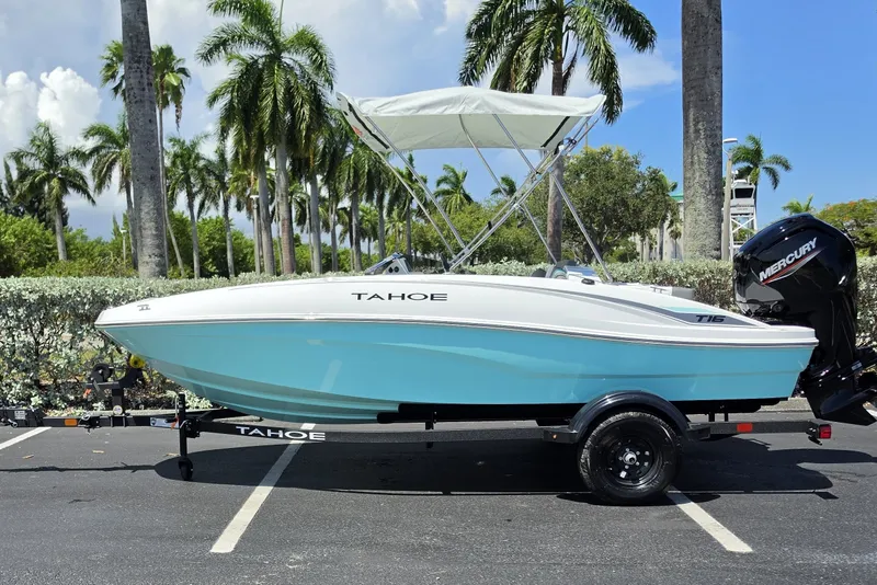 The Image of 2027 Tahoe T16 boat with Mercury engine, parked under palm trees on a sunny day. - 0