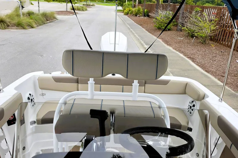 Slide: The Image of Interior view of 2027 Tahoe 2150 CC boat with beige seating and steering wheel. - 14